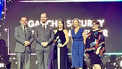 Receiving the award are Drew Nichols - Lead Engineer GSOC, Chad Stroot - Lead Analyst GSOC, Rachelle Hall, Susan Campbell, and Tiffany Hernandez.