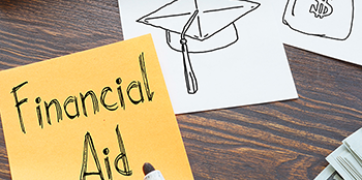 Yellow sticky note with the words Financial Aid