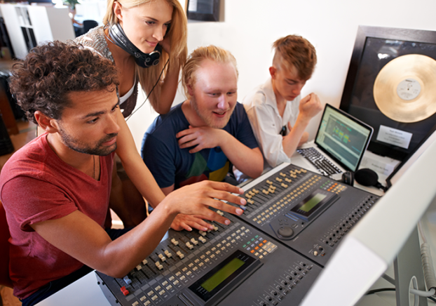 A picture of students working with music production equipment.